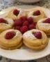 Finished Cookies Citron Framboise beautifully presented with raspberries and powdered sugar.