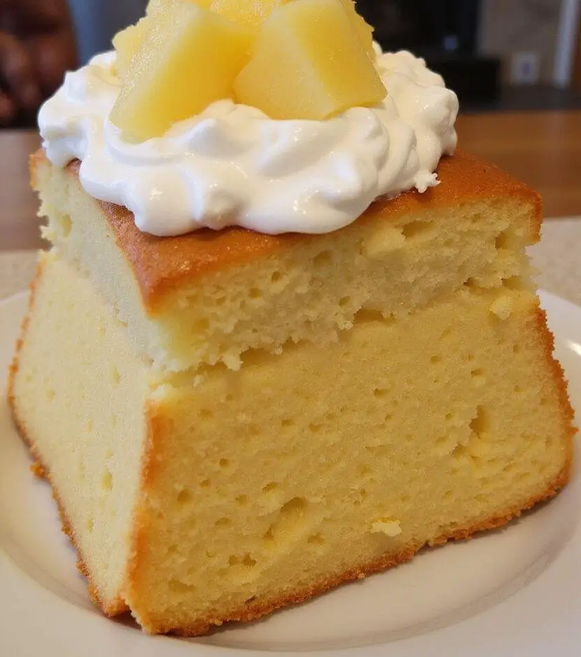 Delicious Gâteau Moelleux à l'Ananas presented with creamy toppings, perfect for dessert.
