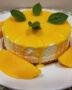 Finished Gateau à la Mangue Exotique garnished with fresh mango and mint, perfect for serving.