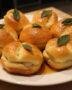 Finished Petits Pains Briochés au Beurre de Sauge et Miel Salé, beautifully arranged for serving with honey glaze and sage.