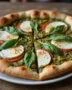 Finished Pizza Caprese au Pesto sur Pâte Feuilletée with fresh basil, ideal for serving.