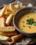 Crispy Frites served with Sauce Crémeuse au Fromage, perfect for a delectable snack.